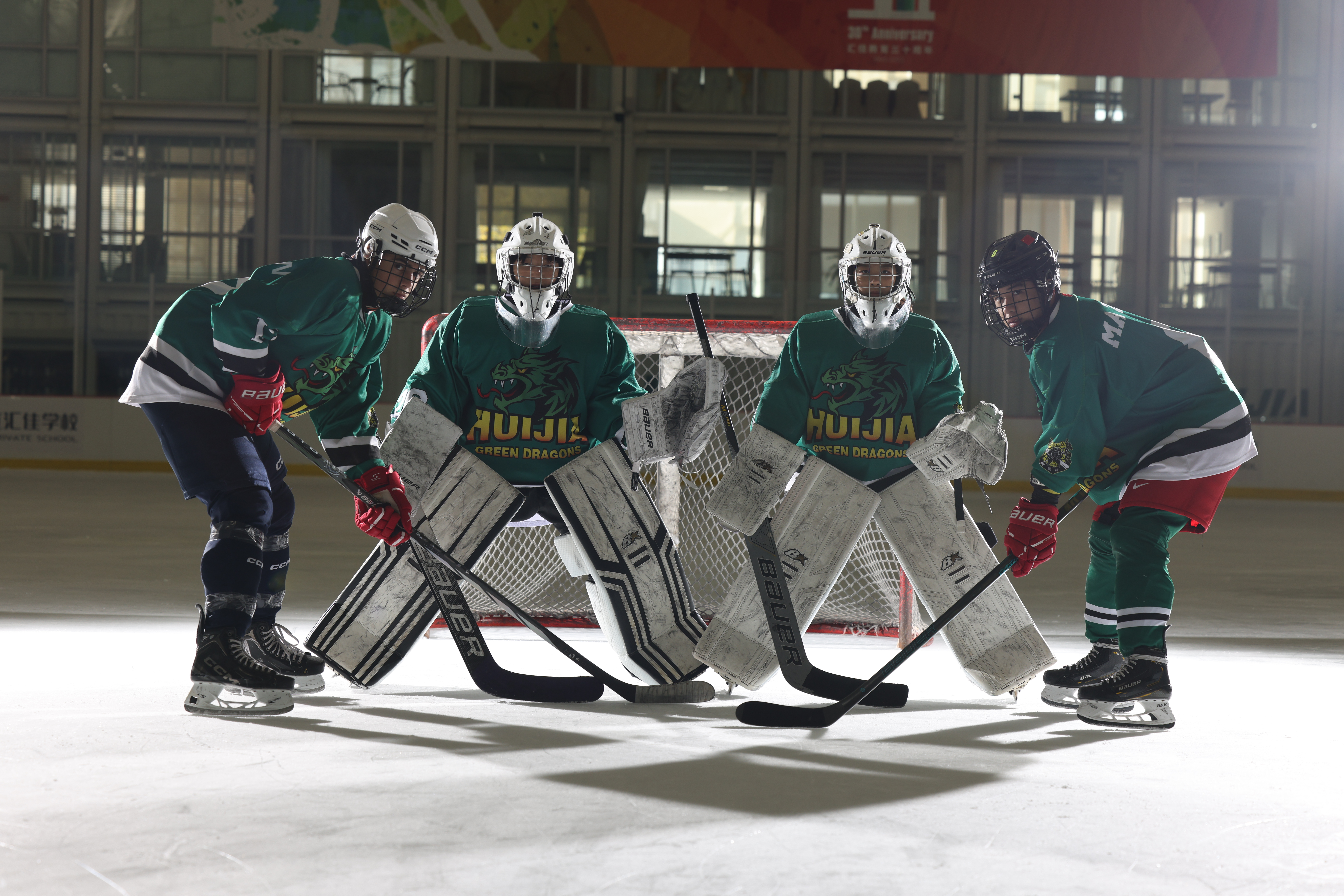 Students playing sports on an ice rink during the summer academy
